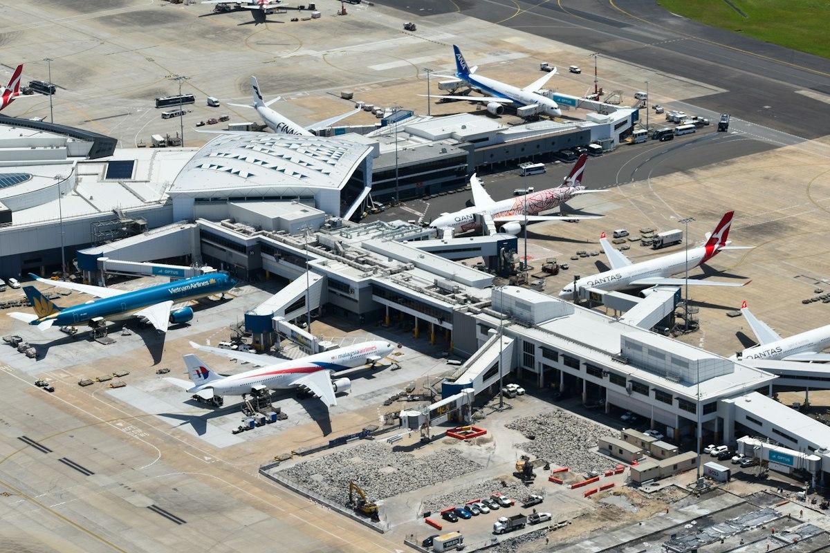 Aerial view of an airport terminal with parked aircraft