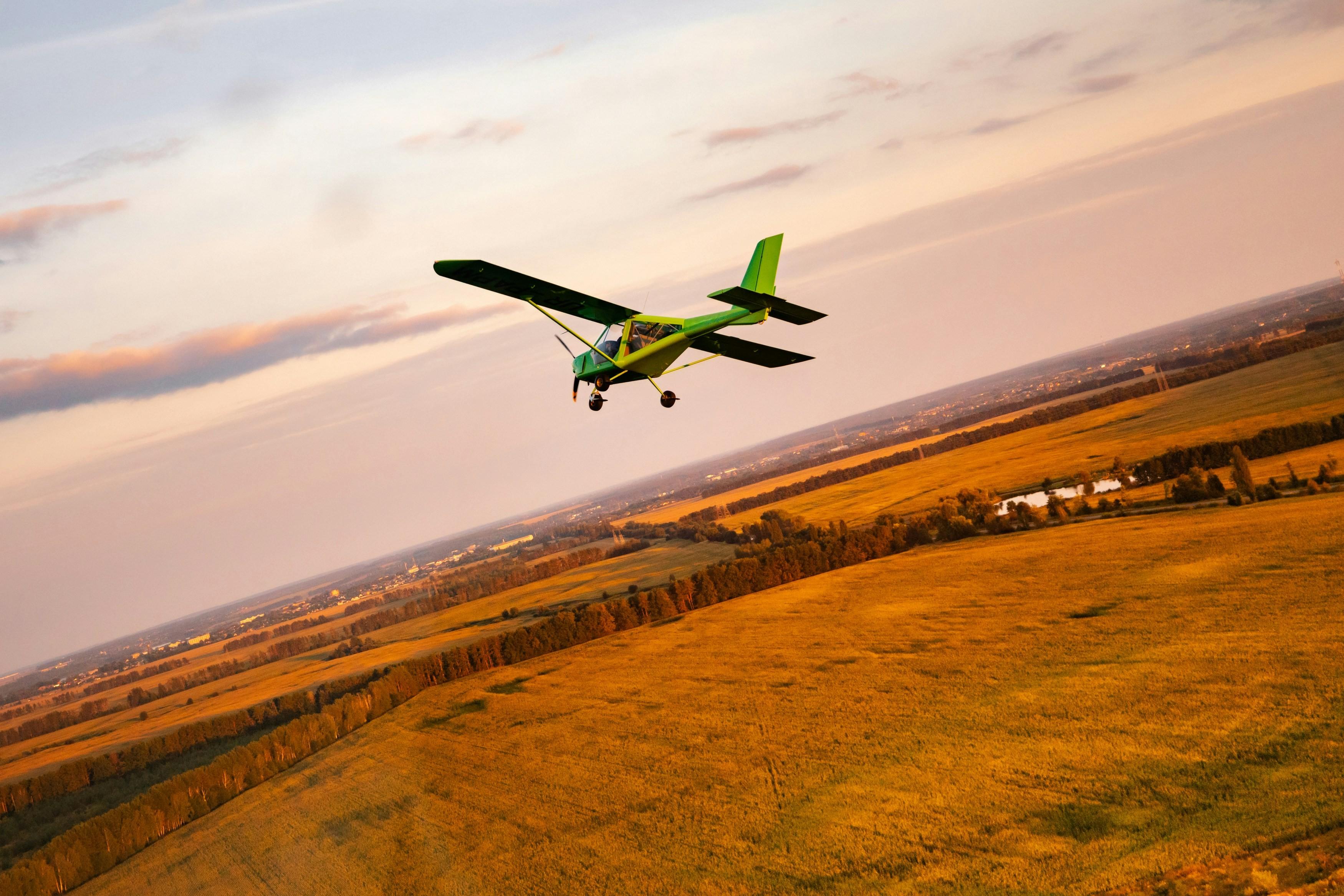 Small twin-engine aircraft on the runway at twilight, with airfield lights glowing