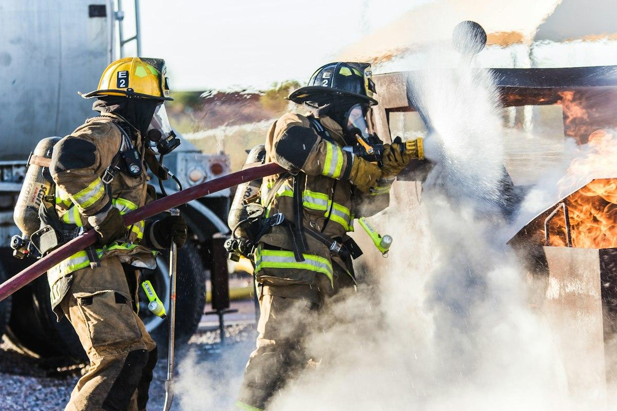 Firefighters spraying water onto a fire